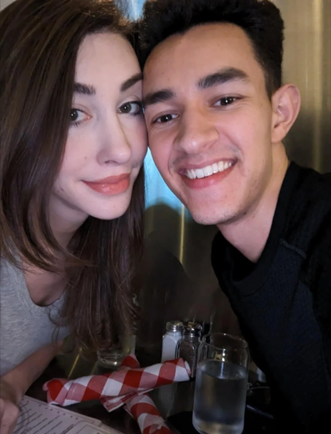Alexander and Aubrey smiling together at dinner